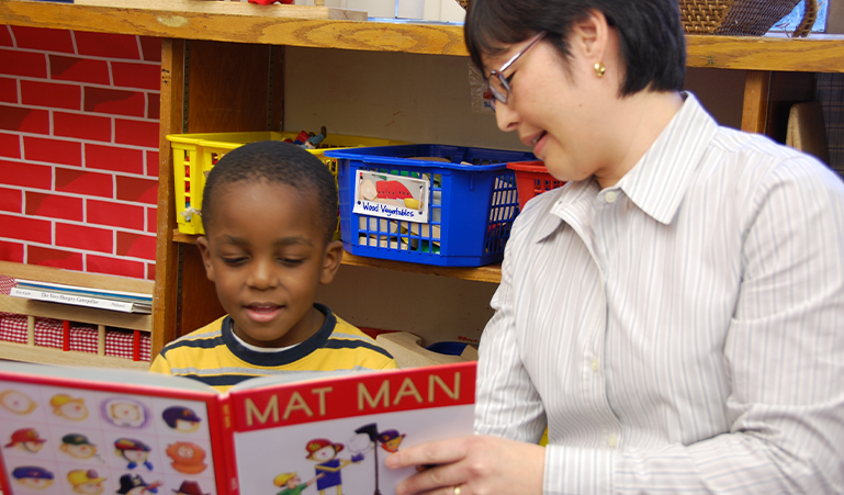 Teacher reading a grade-level book with student