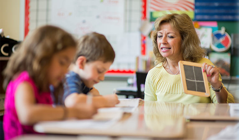 Occupational therapist helps students learn handwriting with hands-on tools.