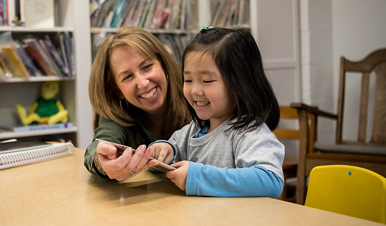 Student and Teacher enjoying a class lesson on a tablet