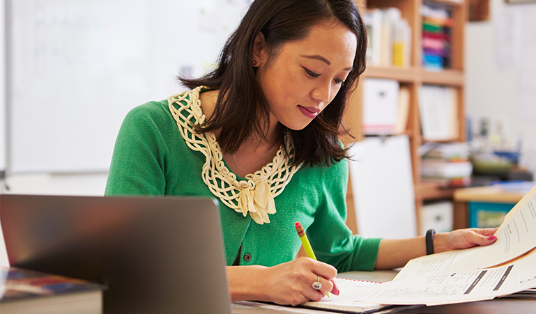 Teacher assessing student handwriting work