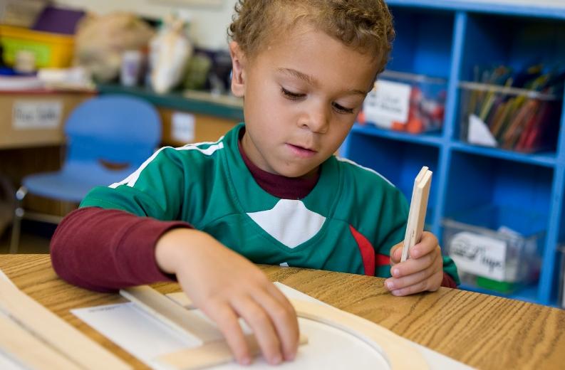 Child engaged in hands-on learning with educational manipulatives