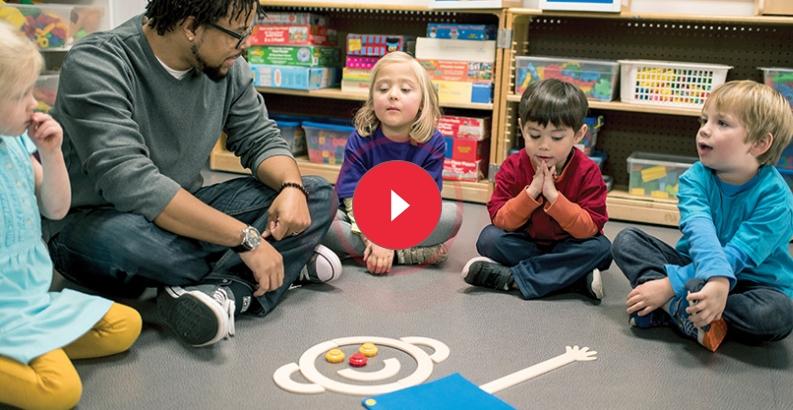 Educator engaging children in a classroom activity with Mat Man to teach body awareness and social-emotional skills