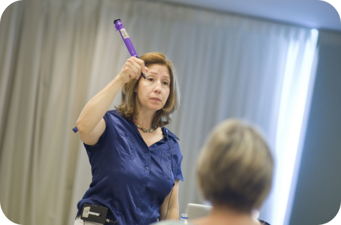 Instructor demonstrates a purple handwriting tool during a professional development workshop focused on writing and fine motor skills.