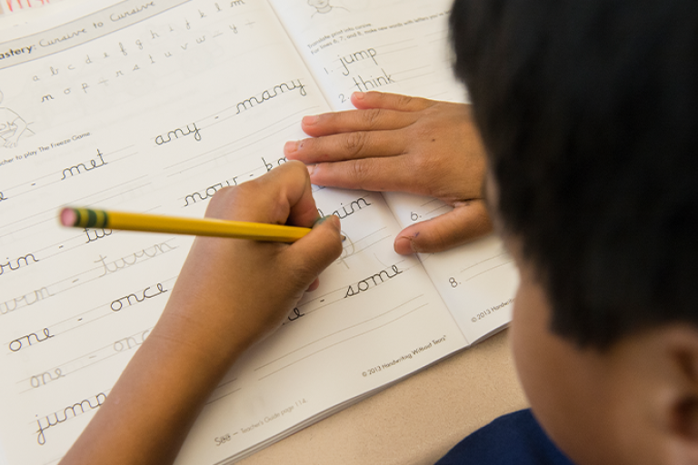 Student practicing cursive writing